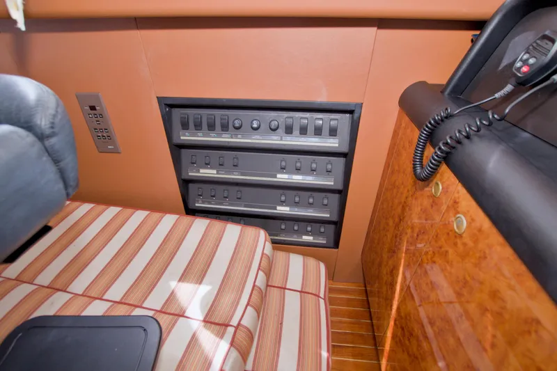 Slide: The Image of Control panel and seating area inside a 1998 Lazzara 76 Skylounge Grand Salon yacht. - 57