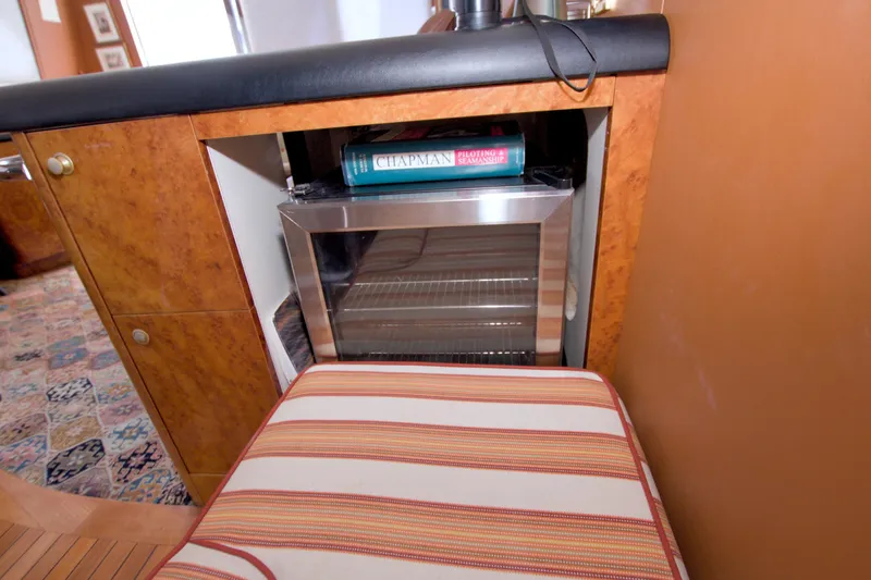 Slide: The Image of Luxury yacht interior with a mini fridge and striped seating, Lazzara 76 Skylounge Grand Salon, 1998. - 58