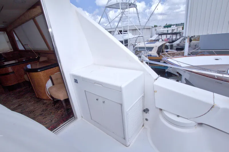 Slide: The Image of 1998 Lazzara 76 Skylounge Grand Salon yacht interior and exterior view at marina. - 61