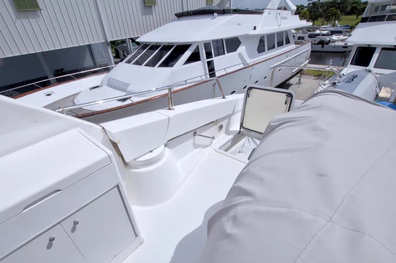 Slide: The Image of 1998 Lazzara 76 Skylounge Grand Salon yacht deck with storage and covered equipment. - 62