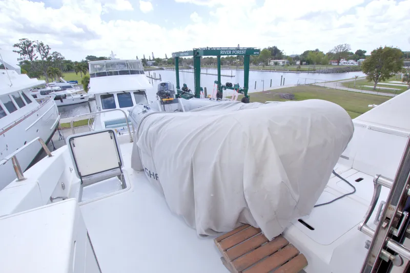 Slide: The Image of 1998 Lazzara 76 Skylounge Grand Salon yacht docked at marina with covered equipment. - 63