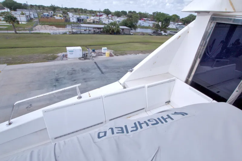 Slide: The Image of 1998 Lazzara 76 Skylounge Grand Salon yacht docked near residential area. - 66