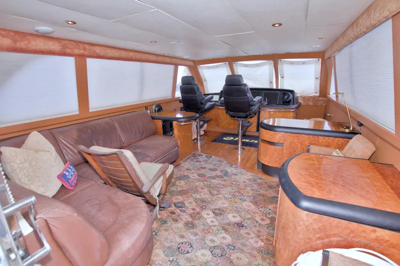 Slide: The Image of Luxurious interior of 1998 Lazzara 76 Skylounge Grand Salon yacht with leather seating and helm. - 67