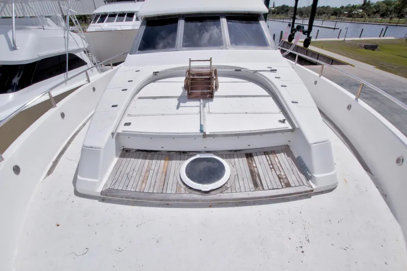 Slide: The Image of 1998 Lazzara 76 Skylounge Grand Salon yacht deck with wooden accents and hatch. - 75