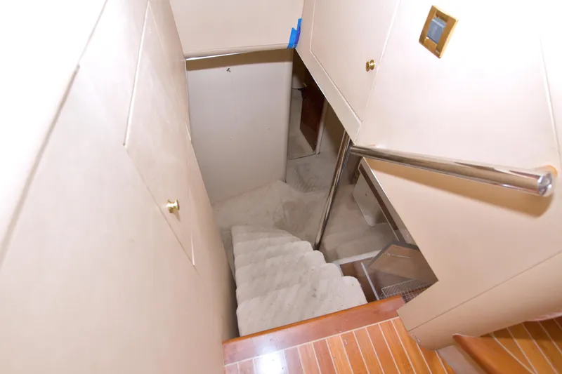 Slide: The Image of Staircase inside 1998 Lazzara 76 Skylounge Grand Salon yacht, featuring sleek design and polished handrails. - 83