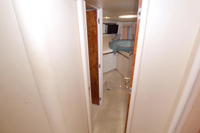 Slide: The Image of Interior hallway of 1998 Lazzara 76 Skylounge Grand Salon yacht, leading to cozy bedroom. - 88