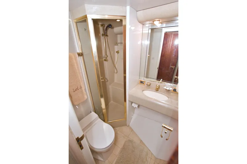 Slide: The Image of Luxurious bathroom in 1998 Lazzara 76 Skylounge Grand Salon yacht with gold accents. - 89