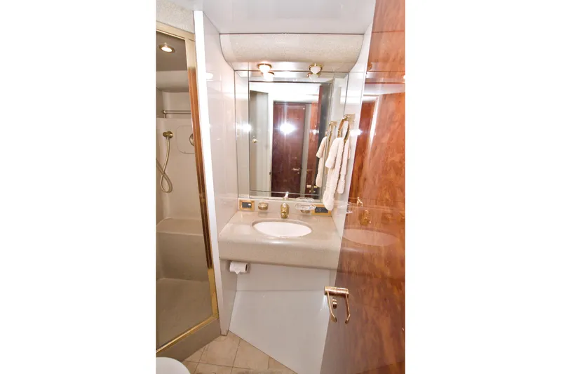 Slide: The Image of Luxurious bathroom in 1998 Lazzara 76 Skylounge Grand Salon yacht, featuring elegant fixtures and wood accents. - 90
