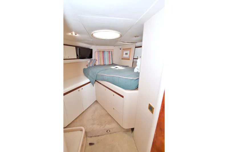 Slide: The Image of 1998 Lazzara 76 Skylounge Grand Salon yacht bedroom with cozy bed and modern decor. - 92