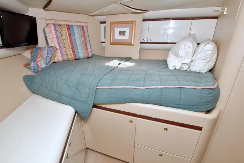 Slide: The Image of Cozy bedroom interior of 1998 Lazzara 76 Skylounge Grand Salon yacht with colorful pillows. - 95