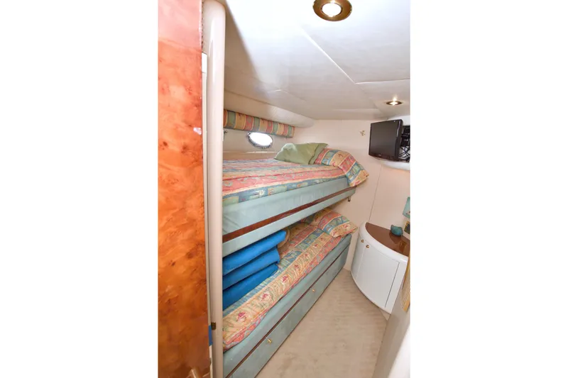 Slide: The Image of Bunk beds in 1998 Lazzara 76 Skylounge Grand Salon yacht cabin with colorful bedding. - 98