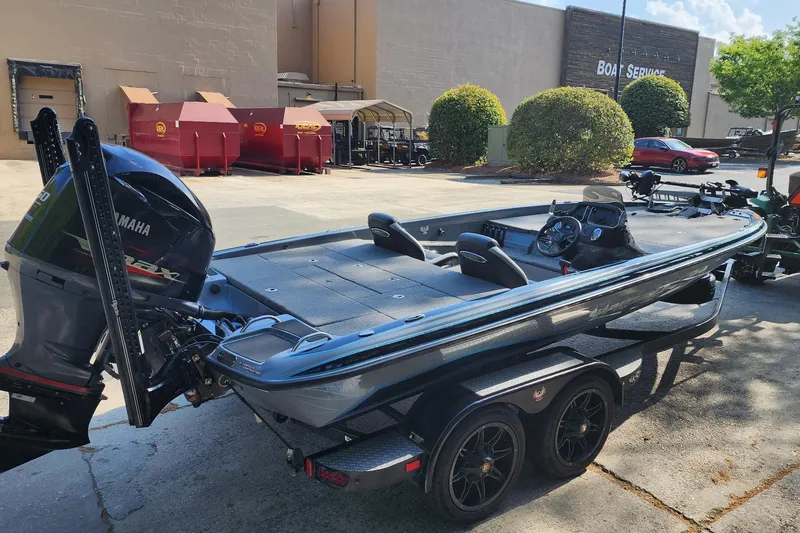 Slide: The Image of 2020 Phoenix 920 Elite boat with Yamaha engine in a boat service area. - 3