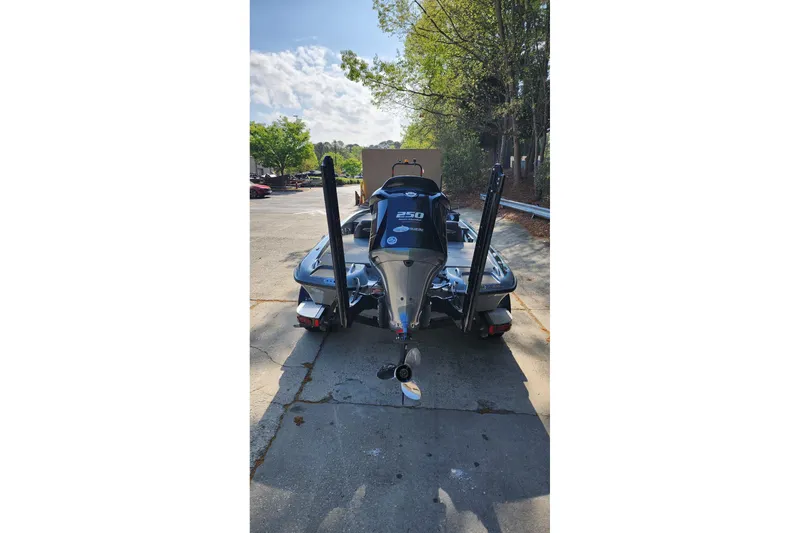 Slide: The Image of 2020 Phoenix 920 Elite boat with powerful outboard motor, parked outdoors. - 4