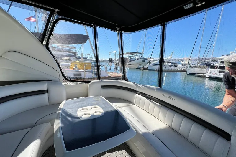 Slide: The Image of Interior view of 2005 Sea Ray 390 Sundancer yacht at marina, featuring luxurious seating. - 10