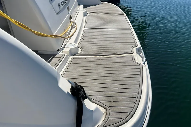 Slide: The Image of 2005 Sea Ray 390 Sundancer swim platform with teak decking, docked on calm water. - 11