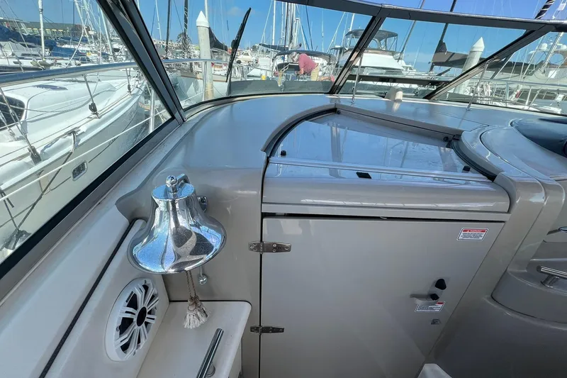 Slide: The Image of 2005 Sea Ray 390 Sundancer cockpit with bell and marina view. - 13
