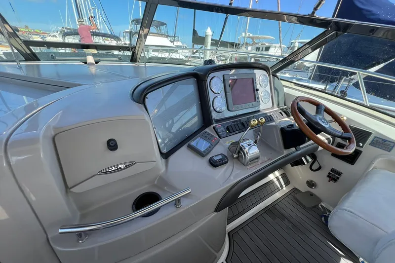 Slide: The Image of Helm of 2005 Sea Ray 390 Sundancer with modern controls and wooden steering wheel. - 15