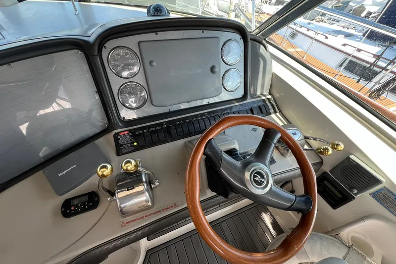Slide: The Image of 2005 Sea Ray 390 Sundancer helm with wooden steering wheel and instrument panel. - 16