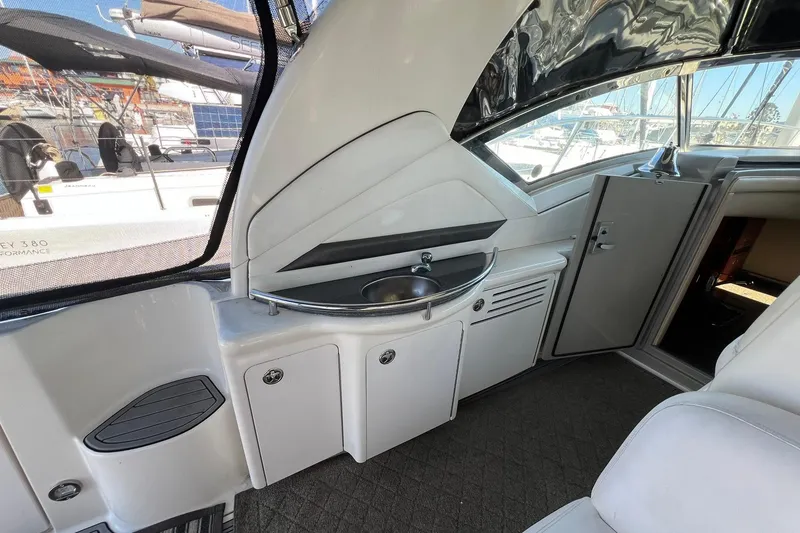 Slide: The Image of 2005 Sea Ray 390 Sundancer interior with sink and storage cabinets. - 17