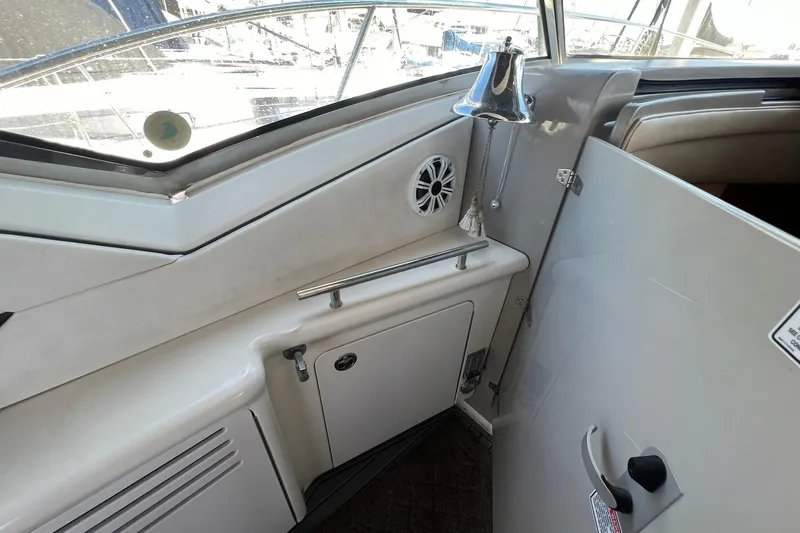 Slide: The Image of 2005 Sea Ray 390 Sundancer interior with bell, speaker, and storage compartment. - 18