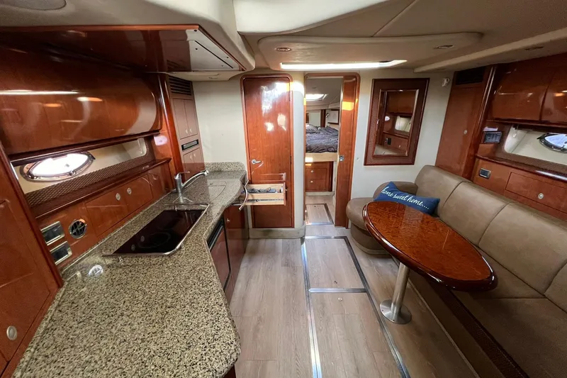 Slide: The Image of Luxurious interior of 2005 Sea Ray 390 Sundancer yacht with modern kitchen and seating area. - 20