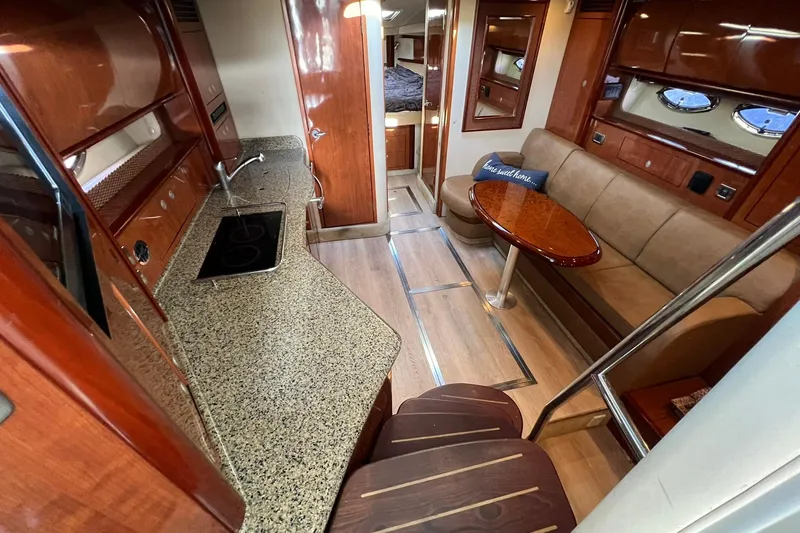 Slide: The Image of Luxurious interior of 2005 Sea Ray 390 Sundancer yacht with kitchen and seating area. - 21