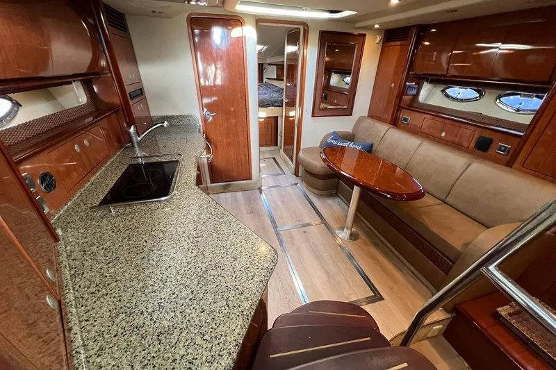 Slide: The Image of Luxurious interior of 2005 Sea Ray 390 Sundancer yacht with kitchen and seating area. - 22