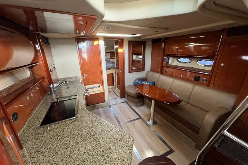 Slide: The Image of Luxurious interior of 2005 Sea Ray 390 Sundancer yacht with modern kitchen and seating area. - 23