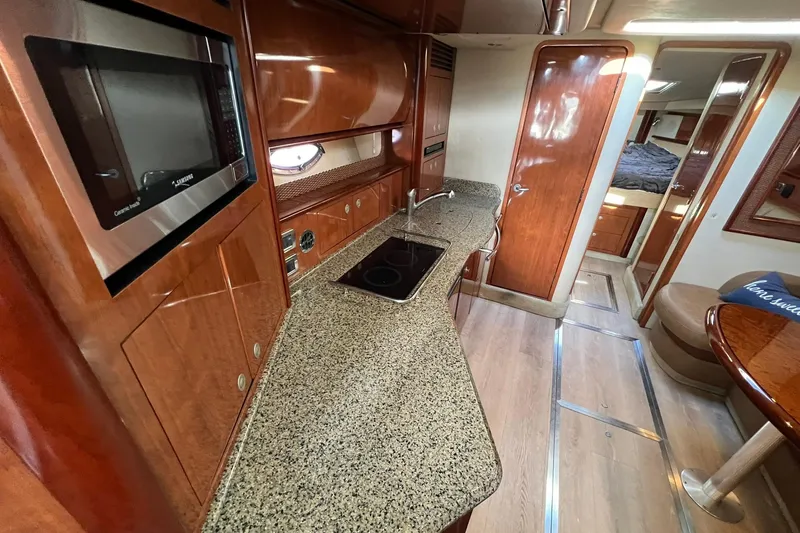 Slide: The Image of Luxurious interior of 2005 Sea Ray 390 Sundancer yacht with modern kitchen amenities. - 24
