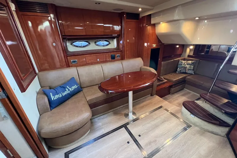 Slide: The Image of Luxurious interior of 2005 Sea Ray 390 Sundancer yacht with plush seating and wooden accents. - 27