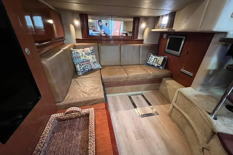Slide: The Image of Interior of 2005 Sea Ray 390 Sundancer yacht with leather seating and decorative pillows. - 28