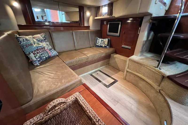 Slide: The Image of Interior of 2005 Sea Ray 390 Sundancer with leather seating and decorative pillows. - 29