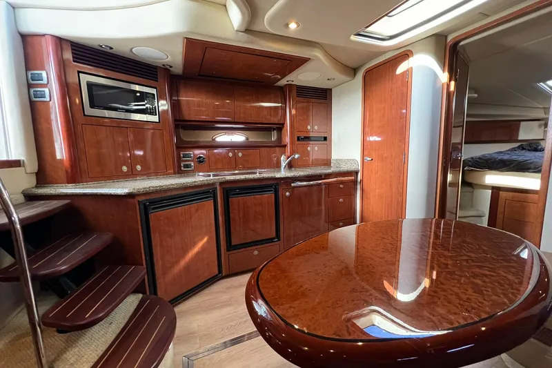 Slide: The Image of Luxurious interior of 2005 Sea Ray 390 Sundancer yacht with wood cabinetry and modern amenities. - 30
