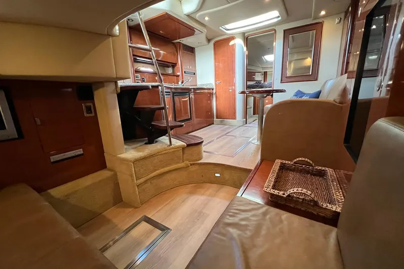 Slide: The Image of Luxurious interior of a 2005 Sea Ray 390 Sundancer yacht, featuring wood finishes and cozy seating. - 32