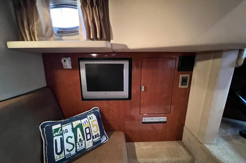 Slide: The Image of Interior of 2005 Sea Ray 390 Sundancer with TV, cushion, and porthole window. - 33