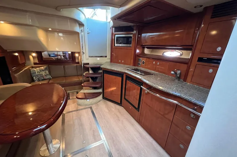 Slide: The Image of Luxurious interior of 2005 Sea Ray 390 Sundancer yacht with modern kitchen and seating area. - 39