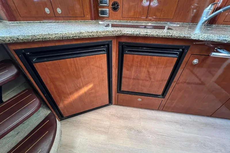 Slide: The Image of 2005 Sea Ray 390 Sundancer galley with wood cabinetry and granite countertop. - 40