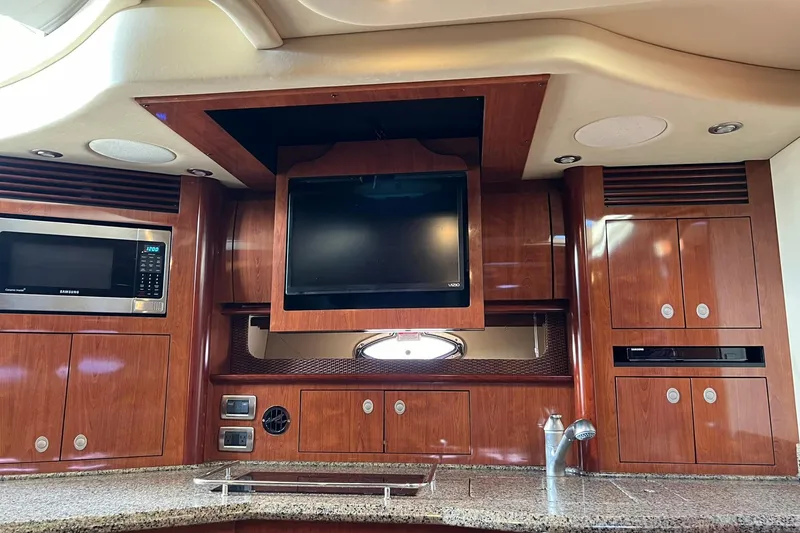 Slide: The Image of Interior of 2005 Sea Ray 390 Sundancer yacht with wood cabinetry and modern appliances. - 43
