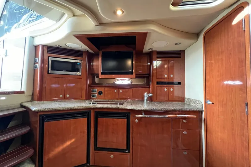 Slide: The Image of Luxurious 2005 Sea Ray 390 Sundancer yacht interior with modern kitchen amenities. - 45