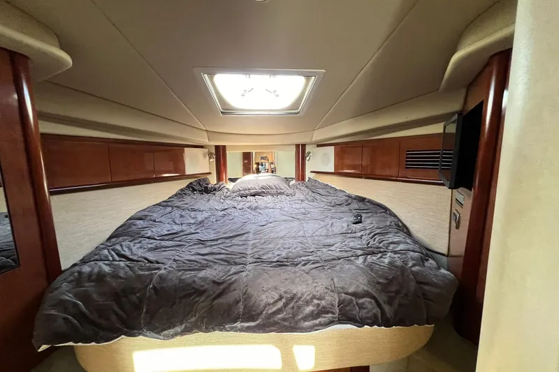 Slide: The Image of Luxurious cabin interior of 2005 Sea Ray 390 Sundancer yacht with plush bedding. - 48