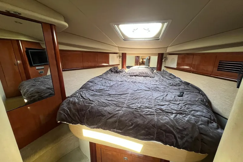 Slide: The Image of Luxurious cabin interior of 2005 Sea Ray 390 Sundancer yacht with plush bedding. - 49