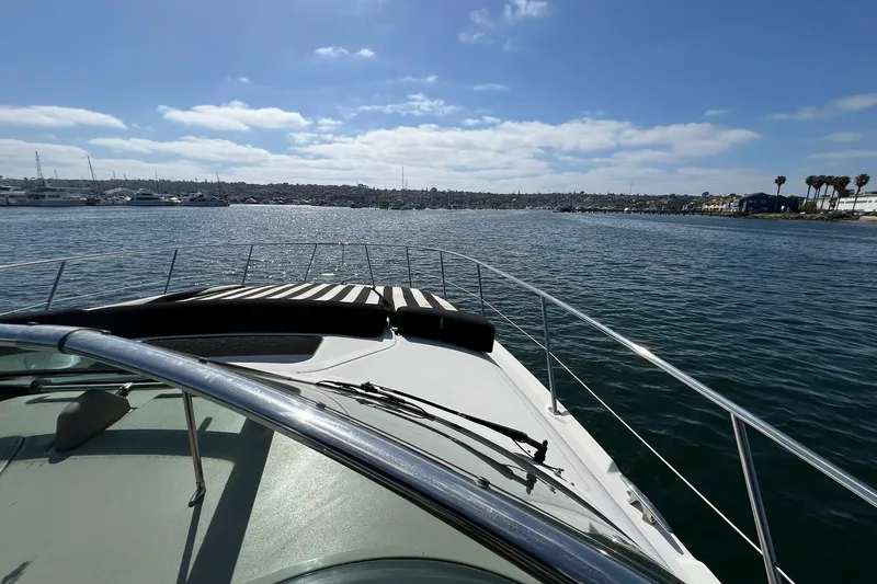 Slide: The Image of 2005 Sea Ray 390 Sundancer cruising on a sunny day with coastal view. - 5