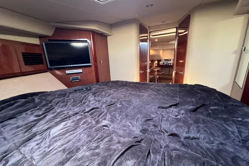 Slide: The Image of Luxurious interior of 2005 Sea Ray 390 Sundancer yacht with plush bedding and TV. - 51