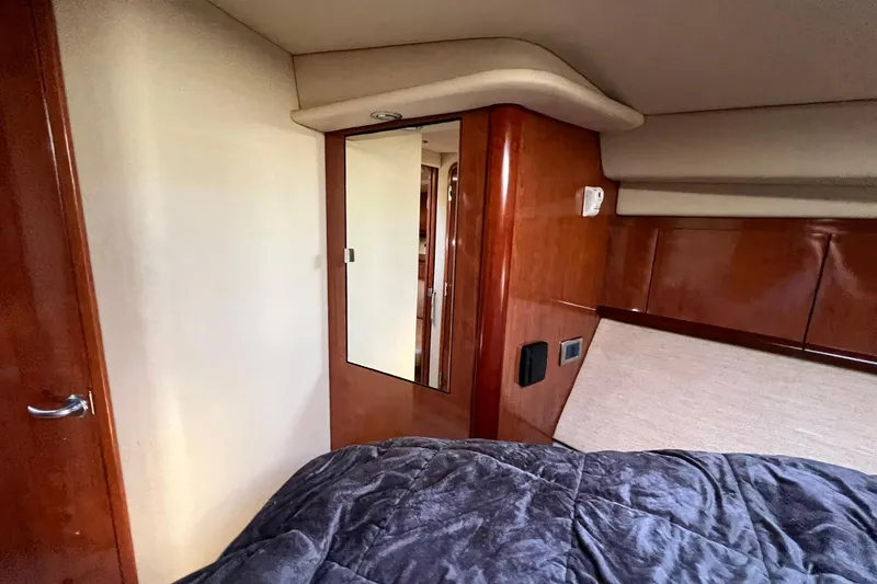 Slide: The Image of Interior cabin of 2005 Sea Ray 390 Sundancer yacht with wood paneling and mirror. - 52
