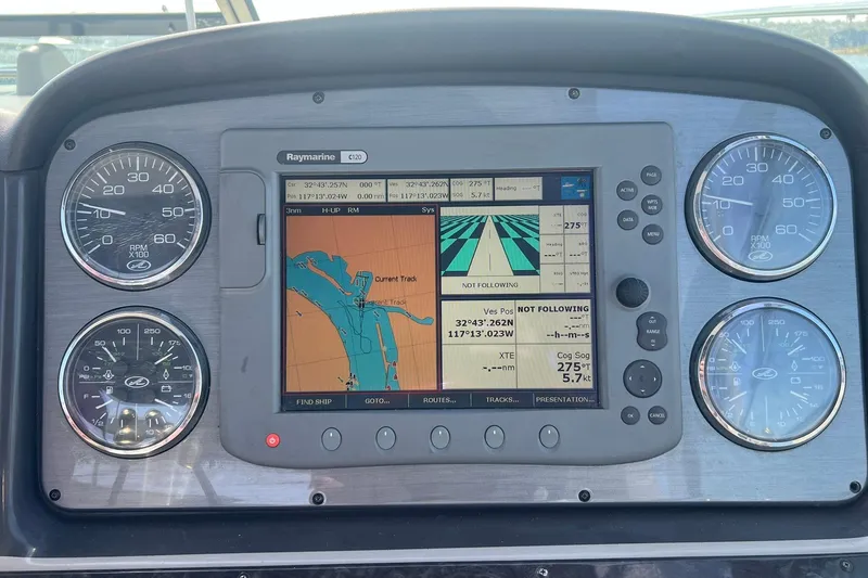 Slide: The Image of Dashboard of a 2005 Sea Ray 390 Sundancer with navigation and gauges. - 56