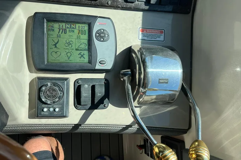 Slide: The Image of Control panel of a 2005 Sea Ray 390 Sundancer boat with throttle and display. - 57