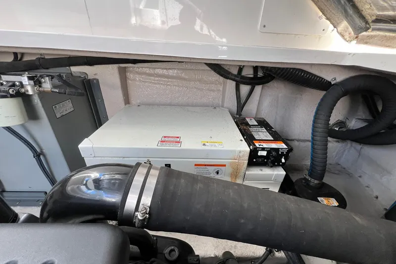 Slide: The Image of Engine compartment of a 2005 Sea Ray 390 Sundancer with visible components and wiring. - 63