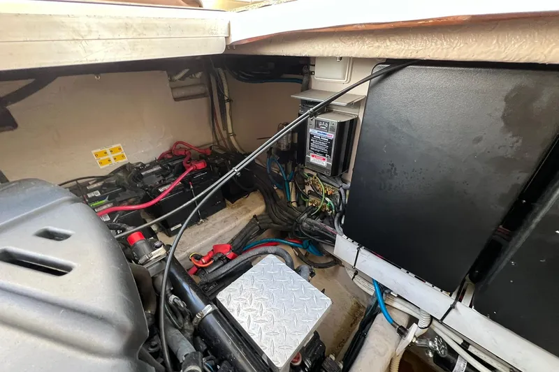 Slide: The Image of Engine compartment of a 2005 Sea Ray 390 Sundancer with visible wiring and components. - 65