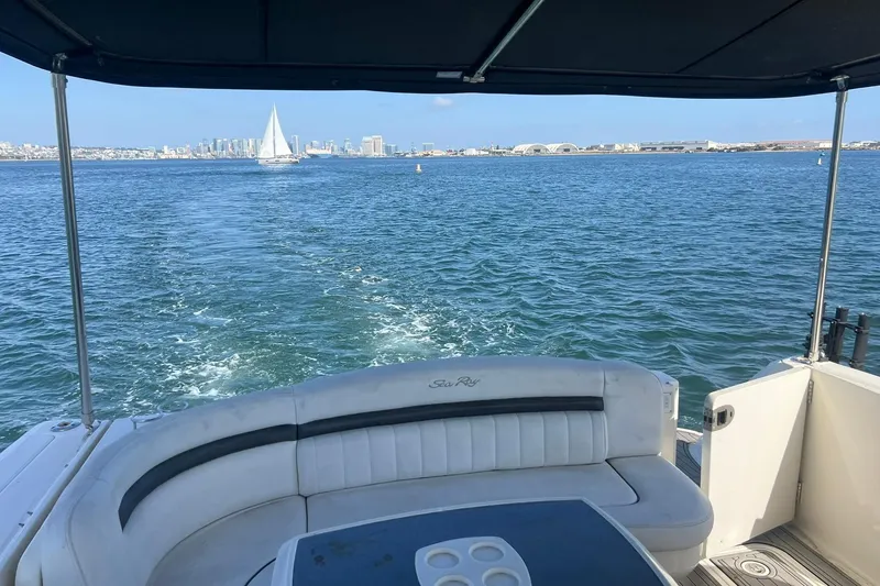 Slide: The Image of 2005 Sea Ray 390 Sundancer cruising with city skyline and sailboat in the background. - 7