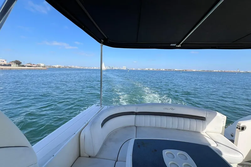 Slide: The Image of 2005 Sea Ray 390 Sundancer cruising on open water under clear blue skies. - 8